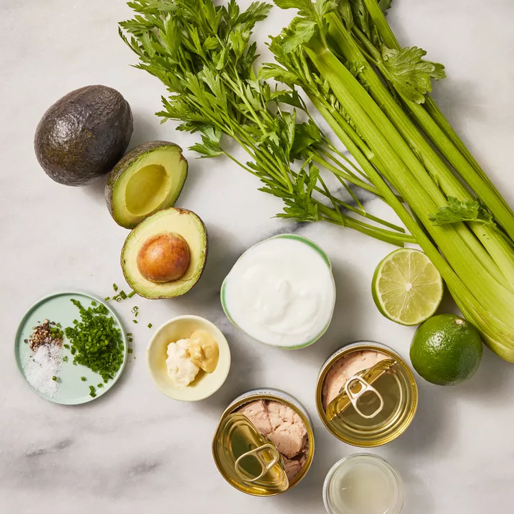 Demi-avocats farcis au saumon, servis frais avec citron et herbes aromatiques ingeridents